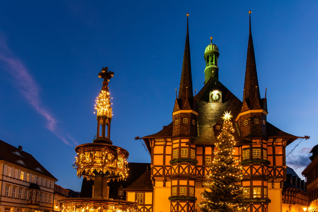 Market square historic city hall Wernigerode in Harz region of Sachsen-Anhalt Land Germany evening night sky. Christmas decoration in old European small scenic town. Scenic Europe travel destination