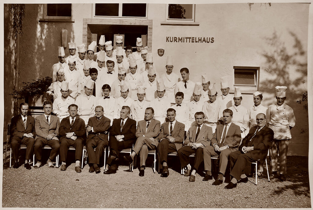 Large group photo of chefs and instructors outside the Kurmittelhaus.