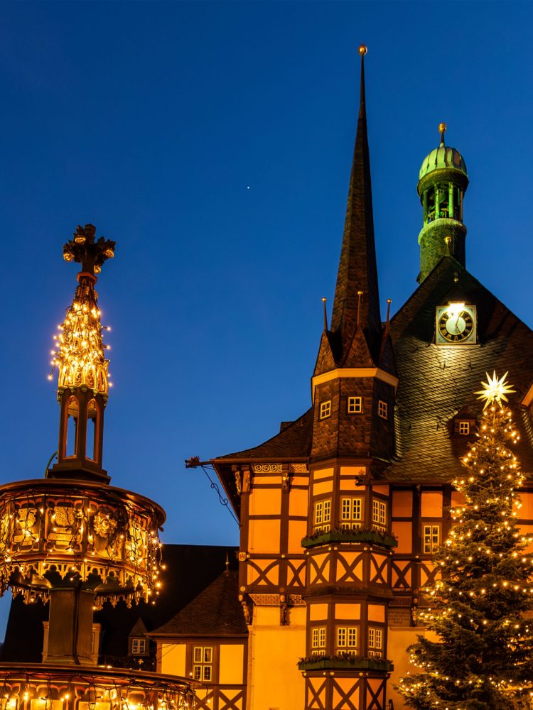 Market square historic city hall Wernigerode in Harz region of Sachsen-Anhalt Land Germany evening night sky. Christmas decoration in old European small scenic town. Scenic Europe travel destination